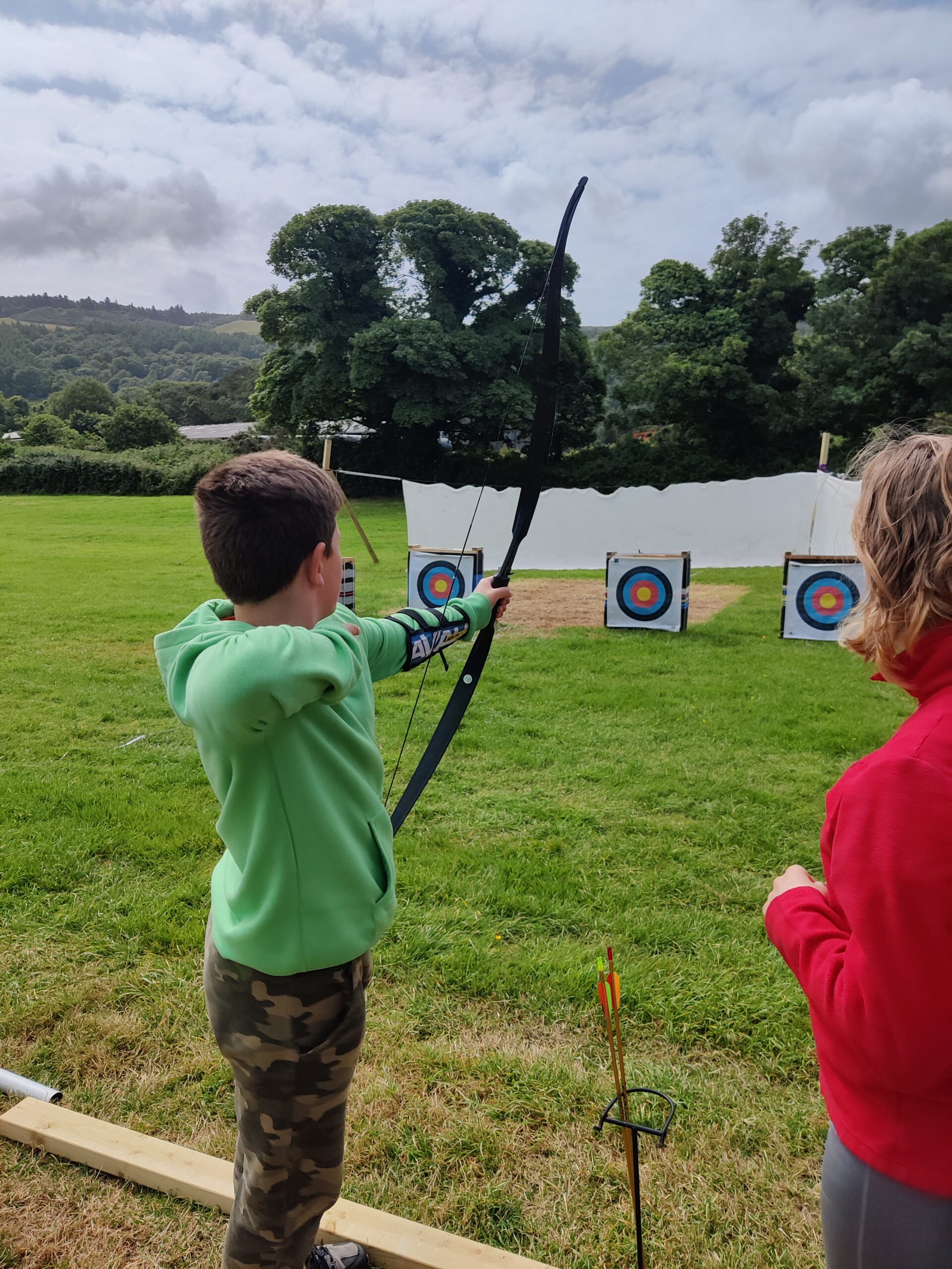 Cubs playing archery